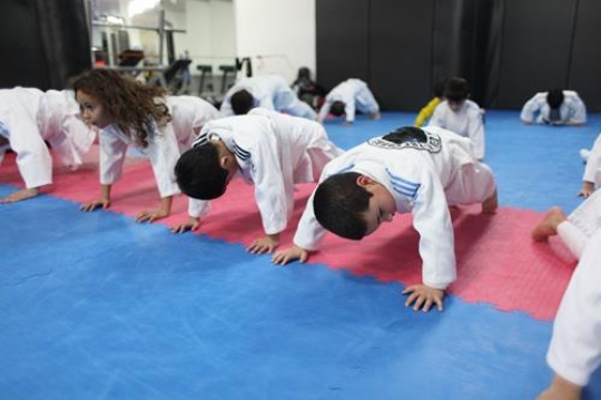 Children in a gym in martial arts training exercising karate, karate fighting Center