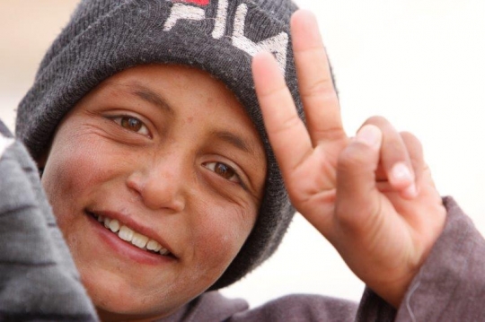 Syrian Kid show victory sign from Zaatari refugee camp for Syrian refugees