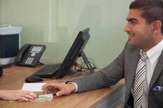 woman giving money to handsome