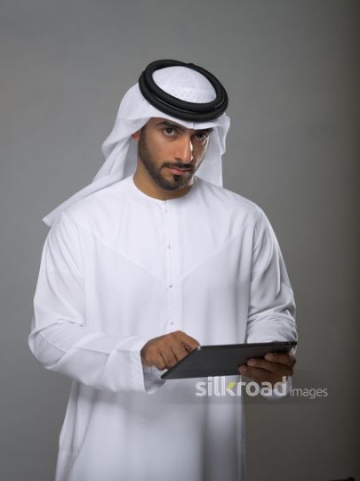 Arabian man typing on his iPad