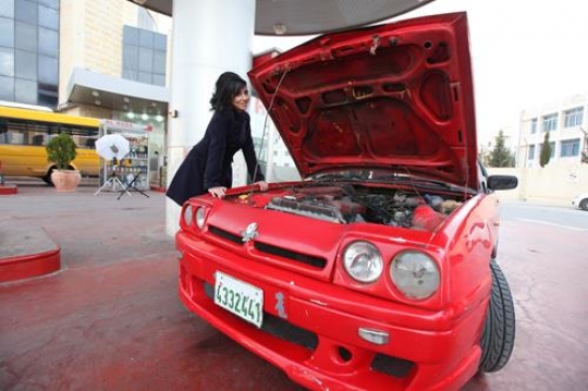 Nice woman mechanic repair broken red car