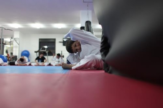 Children in a gym in martial arts training exercising karate, karate fighting Center