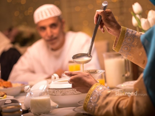 Mother serving soup|-