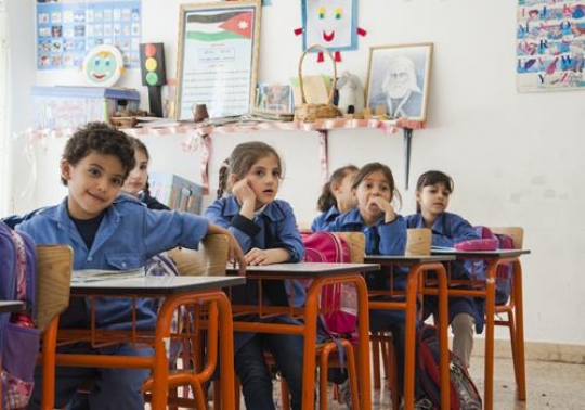group of schoolchildren during lesson in classroom