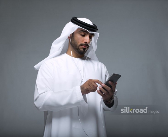 Middle Eastern man using his phone