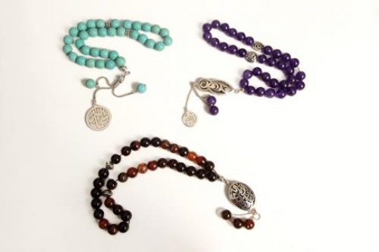 close up of three islamic rosary isolated on white background