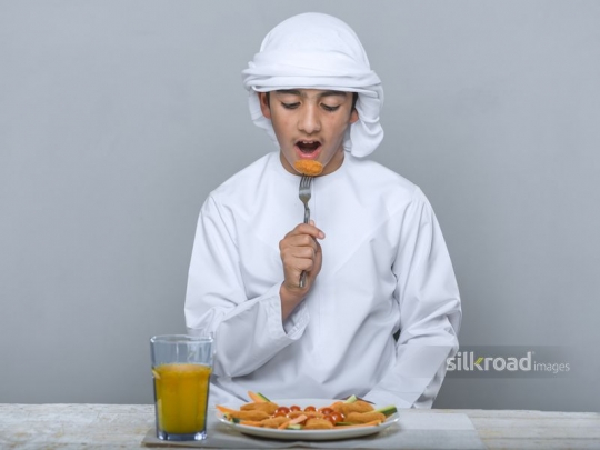 Little boy eating impatiently