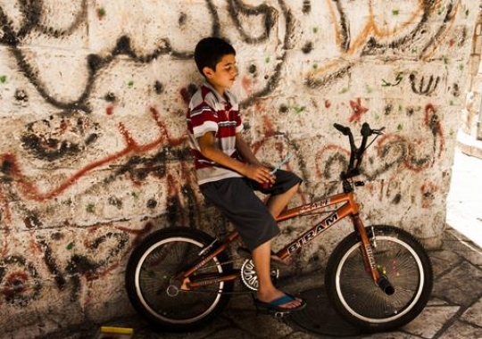 boy in cycling beside the wall