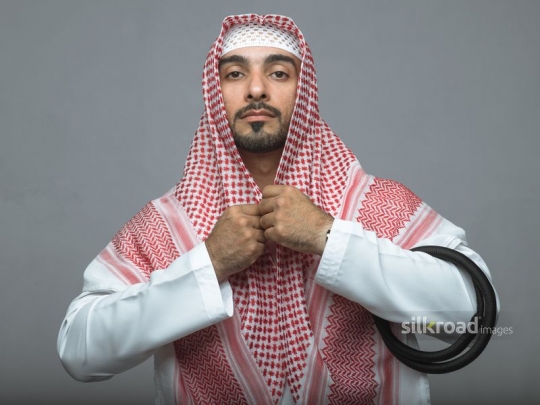 Arabian man fixing his traditional head cover