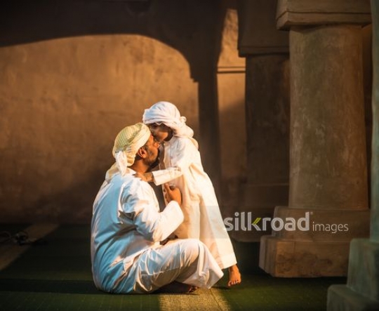 Little boy kissing grandfather|-
