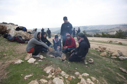 Palestinian demonstrators around the fire at Bab al-Shams or Gate of the Sun
