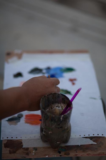 boy painting on a paper with water color