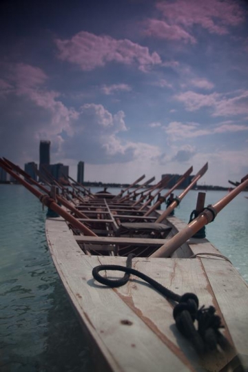 fishing boat with city in background