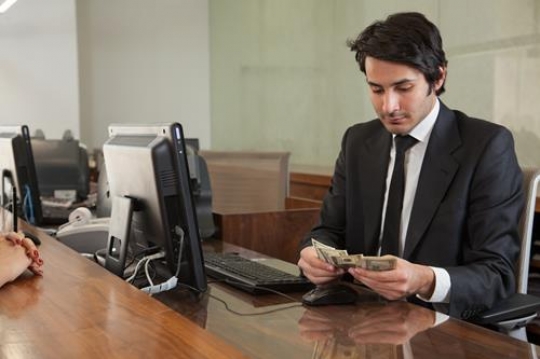 bank teller counting dollar