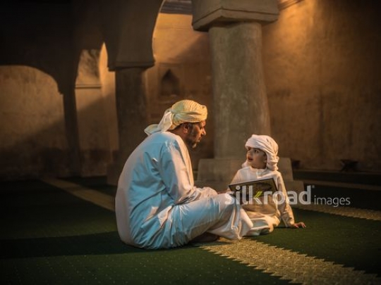 Grandfather reading qur'an with kid|-