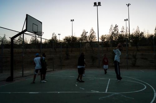 group playing basketball on court