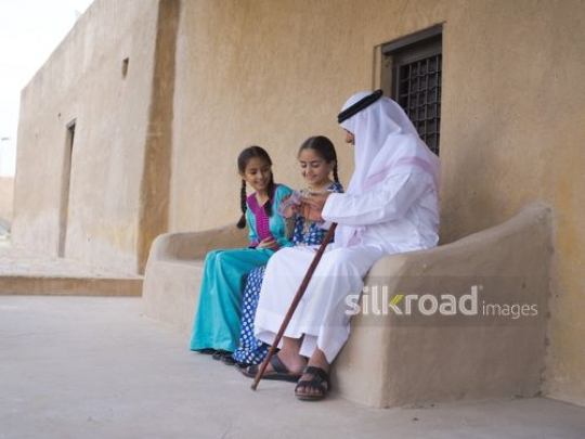 Grandfather giving money to granddaughters|-