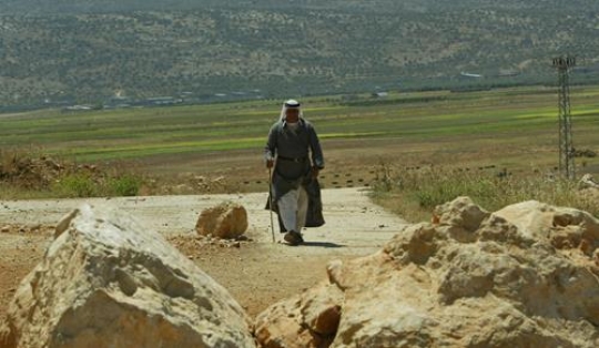 lonely senior man with stick walking away