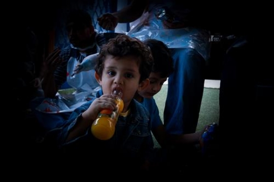 little boy drinking orange jui
