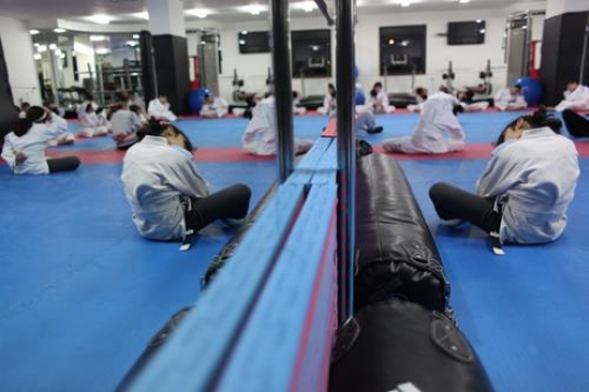 Children in a gym in martial arts training exercising karate, karate fighting Center