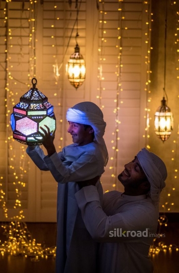 Father carrying son and lantern|-