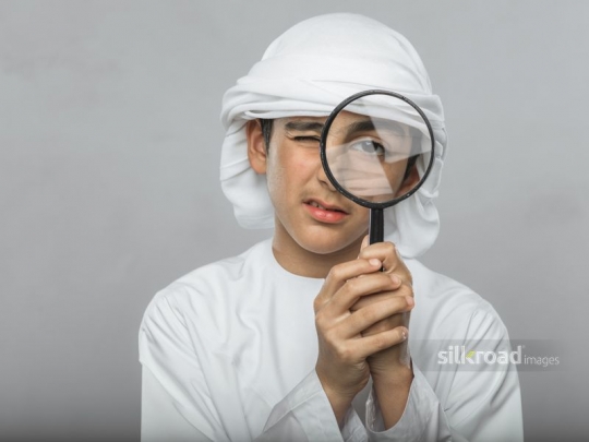 Boy looking through magnifier