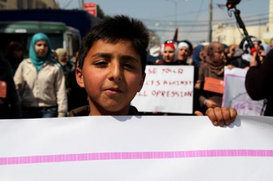 Boy holding protest poster