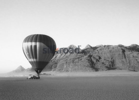 Hot Air Balloon Over Desert Landscape in Wadi Rum, Jordan - Black and White