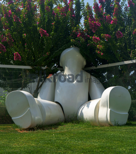 Modern White Sculpture Surrounded by Pink Flowers at Ayla Houses
