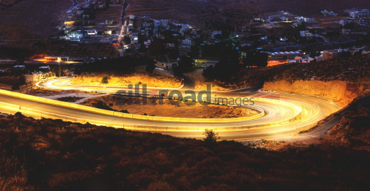 Night View of Winding Road with Light Trails in Zarqa, Jordan
