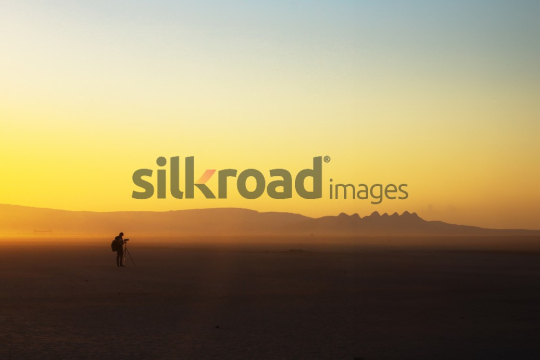 Photographer Capturing the Desert Sunrise in Wadi Rum, Jordan