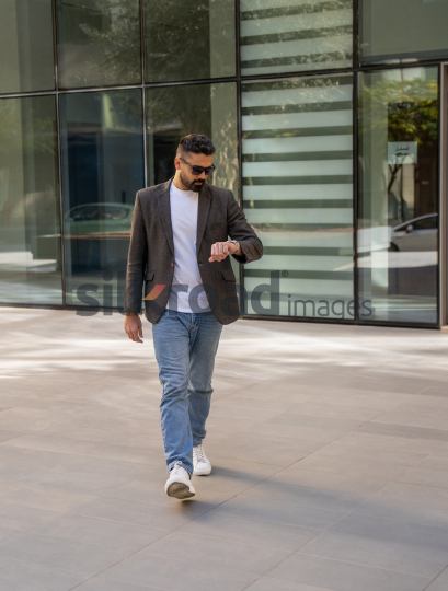 Professional Man Exiting Corporate Building