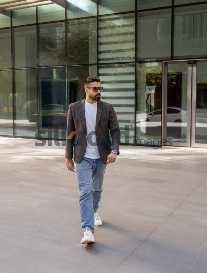 Professional Man Exiting Corporate Building