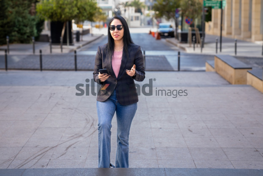 Professional Woman Climbing Stairs and Talking on the Phone