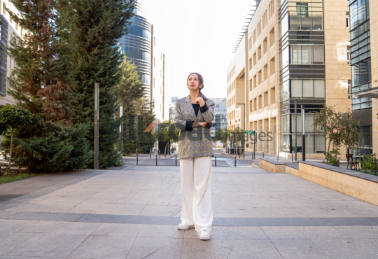 Professional Woman Contemplating Business in the Modern Setting of Al Abdali, Amman Boulevard