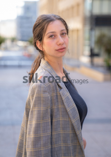 Professional Woman Reflecting on Business Opportunities in Al Abdali, Amman Boulevard (Close-up Shot)