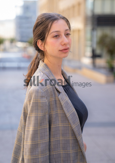 Professional Woman Reflecting on Business Opportunities in Al Abdali, Amman Boulevard (Close-up Shot)