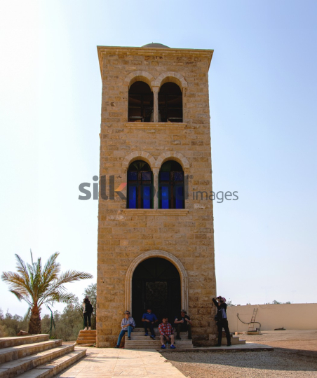 Stone Tower and Visitors at Madaba with Palm Tree