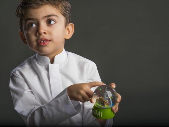 Little boy pointing at snowball