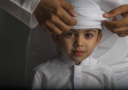Kid dressed in the UAE Kandura