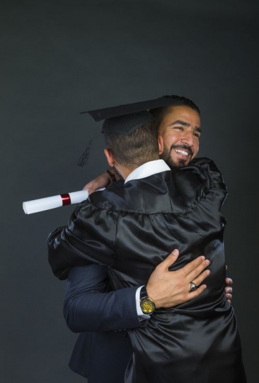 Middle Eastern father hugging his son