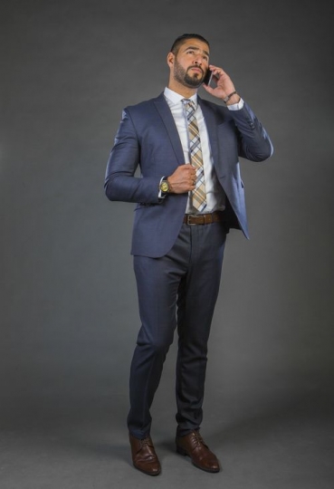 Businessman in a suit talking over the phone|-