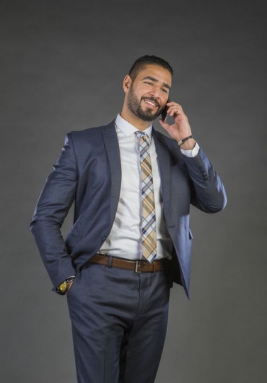 Businessman in a suit speaking over the phone|-