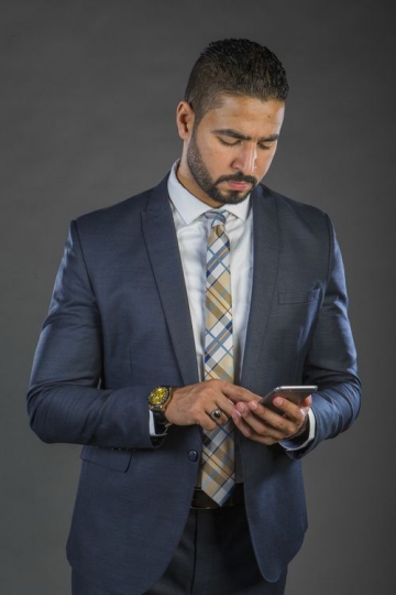 Businessman in a suit texting|-