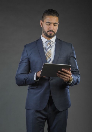 Businessman working off device|-