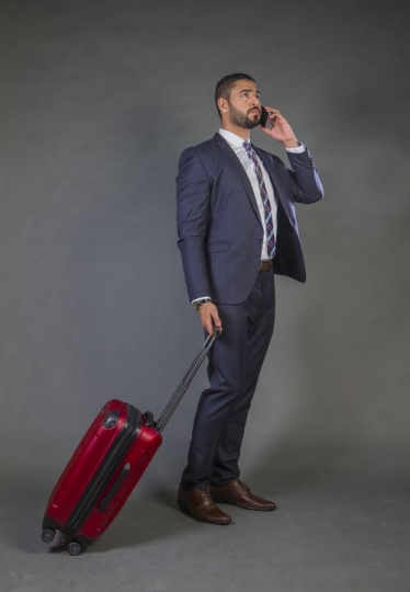 Businessman traveling and speaking over the phone|-