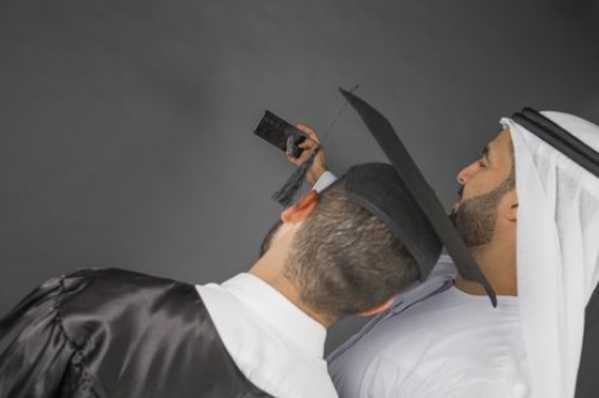 Middle Eastern father and son taking a picture