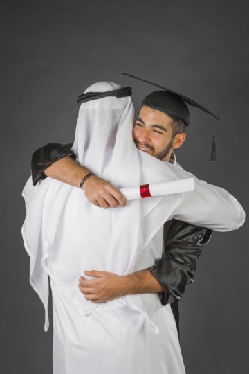Arab man congratulating his son|-