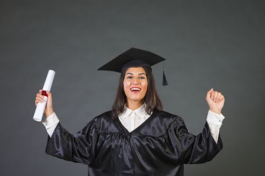 Medium shot of an Arab woman who graduated