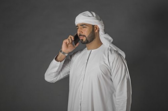 Middle Eastern Businessman talking on the phone|-